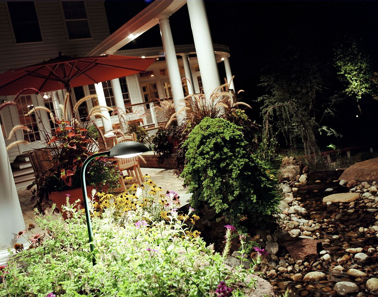 garden lit up using professional outdoor lighting fixtures