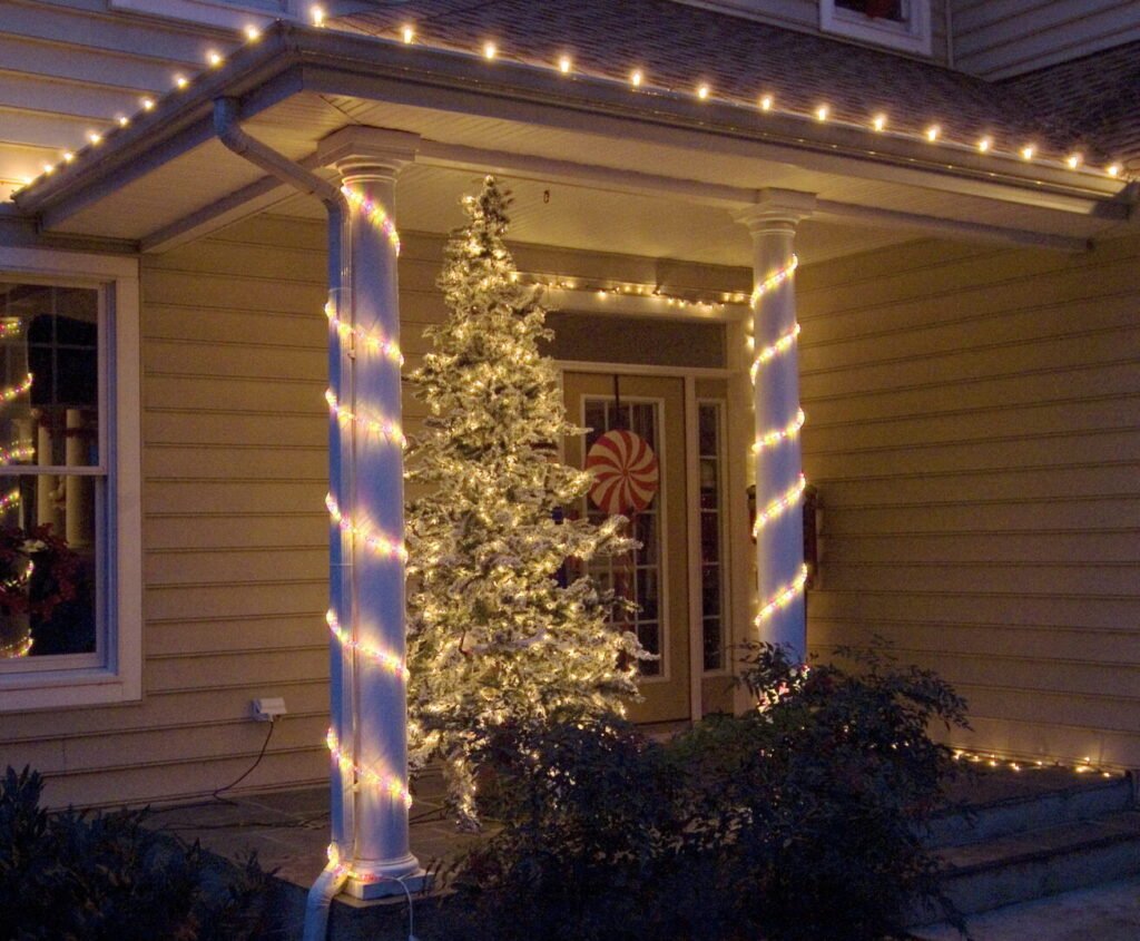 house columns decorated in christmas lighting